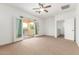 Bright bedroom with ceiling fan, balcony access, and stained glass windows at 2046 E Paradise Ln, Phoenix, AZ 85022