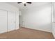 This empty bedroom features carpet, a ceiling fan, and a large window at 2046 E Paradise Ln, Phoenix, AZ 85022