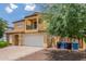 Side view of a yellow two-story home with a well-maintained yard and ample parking at 2046 E Paradise Ln, Phoenix, AZ 85022