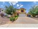 A charming two-story home with desert landscaping, a paved driveway, and a two-car garage at 2046 E Paradise Ln, Phoenix, AZ 85022
