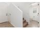 Hallway features staircase, entry door, and an entrance to a half bathroom at 2046 E Paradise Ln, Phoenix, AZ 85022