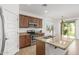 Modern kitchen with granite countertops, stainless steel appliances, and a center island at 2046 E Paradise Ln, Phoenix, AZ 85022