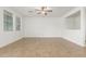 Spacious living room with tile floors, a ceiling fan, and plenty of natural light at 2046 E Paradise Ln, Phoenix, AZ 85022
