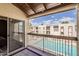 Balcony view showcasing the pool and neighboring building in this well-maintained community at 205 N 74Th St # 227, Mesa, AZ 85207