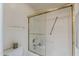 Clean, white bathroom with shower, grab bars, and sliding glass door at 205 N 74Th St # 227, Mesa, AZ 85207