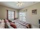 Bright bedroom featuring a ceiling fan, neutral walls, large bed and private balcony access at 205 N 74Th St # 227, Mesa, AZ 85207