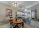 Dining area with a view into the kitchen, with seating for four around a wooden table at 205 N 74Th St # 227, Mesa, AZ 85207