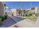 Exterior view of community buildings with gravel, sidewalk and tropical trees at 205 N 74Th St # 227, Mesa, AZ 85207