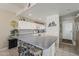 Eat-in kitchen with breakfast bar and white cabinetry offering ample space and storage at 205 N 74Th St # 227, Mesa, AZ 85207