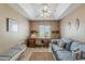 Functional office space featuring built-in desk, ceiling fan, and comfortable seating at 205 N 74Th St # 227, Mesa, AZ 85207