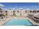 Community pool and lounging area with building backdrop at 205 N 74Th St # 227, Mesa, AZ 85207