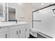 Bright bathroom with a glass-enclosed shower, modern vanity with black hardware, and contrasting black tile flooring at 23010 E Pummelos Rd, Queen Creek, AZ 85142