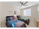 Whimsical bedroom with beds, ceiling fan and playful decor at 23010 E Pummelos Rd, Queen Creek, AZ 85142