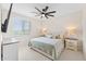 Inviting bedroom with a queen-size bed, soft bedding, and ample natural light from a large window at 23010 E Pummelos Rd, Queen Creek, AZ 85142