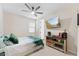 Bright bedroom with a ceiling fan, a mounted TV, and a unique wooden cabinet for a contemporary, stylish feel at 23010 E Pummelos Rd, Queen Creek, AZ 85142