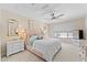 Soft and serene bedroom with a pink tufted headboard, elegant decor, and a bright window for natural light at 23010 E Pummelos Rd, Queen Creek, AZ 85142