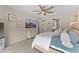 Cozy bedroom with neutral colors, a mounted TV, a dresser with decorative accents, and soft textures for a relaxing feel at 23010 E Pummelos Rd, Queen Creek, AZ 85142