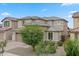 Charming two-story home with a two-car garage and desert landscaping, complemented by mature shade trees at 23010 E Pummelos Rd, Queen Creek, AZ 85142