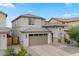 Charming two-story home with a two-car garage and desert landscaping, perfect for curb appeal at 23010 E Pummelos Rd, Queen Creek, AZ 85142
