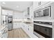 Beautiful white kitchen featuring stainless steel appliances and sleek modern cabinetry at 23010 E Pummelos Rd, Queen Creek, AZ 85142