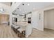 Bright kitchen with a large island with counter seating, white cabinets, and stainless steel appliances at 23010 E Pummelos Rd, Queen Creek, AZ 85142