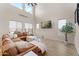 Spacious living room featuring high ceilings, large windows, and a comfortable sectional sofa at 23010 E Pummelos Rd, Queen Creek, AZ 85142