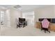 Open loft area with dedicated desks, neutral carpeting, and ample space for a flexible work or relaxation zone at 23010 E Pummelos Rd, Queen Creek, AZ 85142