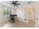 Bright office space featuring a ceiling fan, a window for natural light, and space for a dual monitor desk setup at 23010 E Pummelos Rd, Queen Creek, AZ 85142