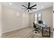 Home office with a modern ceiling fan and a large window providing natural light at 23010 E Pummelos Rd, Queen Creek, AZ 85142