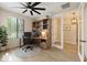 Bright office space, virtually staged, featuring a built-in desk and shelving, a window, and a neutral color palette at 23010 E Pummelos Rd, Queen Creek, AZ 85142