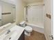 Well-maintained bathroom features a vanity, toilet and shower over tub with shower curtain at 24811 W Wayland Dr, Buckeye, AZ 85326