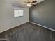Bright, spacious bedroom with a ceiling fan and natural light offers comfort and relaxation at 24811 W Wayland Dr, Buckeye, AZ 85326