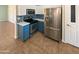 Stylish kitchen featuring stainless steel appliances, white cabinets, and unique blue backsplash and island at 24811 W Wayland Dr, Buckeye, AZ 85326