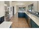 Modern kitchen featuring stainless steel appliances, white cabinets, blue island and subway tile backsplash at 24811 W Wayland Dr, Buckeye, AZ 85326