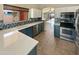 Well-lit kitchen features new appliances, white countertops, blue lower cabinets, and tile backsplash at 24811 W Wayland Dr, Buckeye, AZ 85326