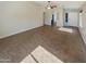 Spacious living room with tile flooring, neutral paint, ceiling fan, and ample natural light at 24811 W Wayland Dr, Buckeye, AZ 85326