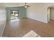 Bright, open living room featuring tile floors, neutral paint, ceiling fan, and sliding glass doors at 24811 W Wayland Dr, Buckeye, AZ 85326