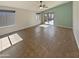 Bright living room featuring tile flooring, a ceiling fan, and sliding glass doors to the backyard at 24811 W Wayland Dr, Buckeye, AZ 85326