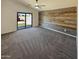 Open main bedroom with accent wall, ceiling fan, sliding glass doors, and neutral carpet at 24811 W Wayland Dr, Buckeye, AZ 85326