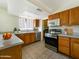 Well-lit kitchen featuring stainless steel appliances, wooden cabinets, and tile flooring at 2575 E Coronita Cir, Chandler, AZ 85225