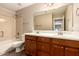 Bathroom with a double sink vanity, large mirror, tub and shower combination, and a toilet at 26080 N 73Rd Ln, Peoria, AZ 85383