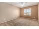 Bedroom with carpet, ceiling fan, and natural light from a window at 26080 N 73Rd Ln, Peoria, AZ 85383