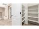 Upstairs hallway features white doors, shelving, and plush neutral carpet at 26080 N 73Rd Ln, Peoria, AZ 85383