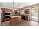 Gourmet kitchen with stainless appliances, center island, and backyard view by the pool at 26080 N 73Rd Ln, Peoria, AZ 85383