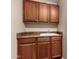 Laundry room featuring wood cabinets, counter, and a sink at 26080 N 73Rd Ln, Peoria, AZ 85383
