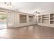 Open concept room with tile flooring, built-in shelves, and views of the backyard pool at 26080 N 73Rd Ln, Peoria, AZ 85383