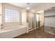 Bright main bathroom features a soaking tub and a separate glass-enclosed shower at 26080 N 73Rd Ln, Peoria, AZ 85383