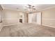 Large main bedroom with ceiling fan and bathroom with dual sinks just off of it at 26080 N 73Rd Ln, Peoria, AZ 85383