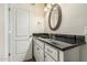 Bathroom featuring granite countertop, white cabinets, and oval mirror at 2807 N 8Th Ave, Phoenix, AZ 85007