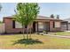 Attractive brick home with a tile roof, covered parking, mature trees, and landscaped front yard at 2807 N 8Th Ave, Phoenix, AZ 85007